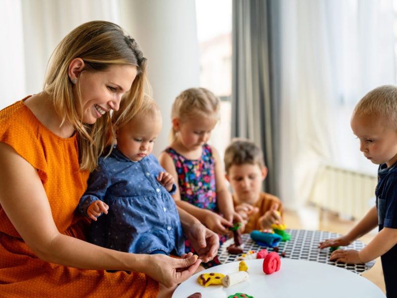 mother-or-nursery-teacher-teaches-her-children-to-work-with-colorful-play-clay-toys.jpg